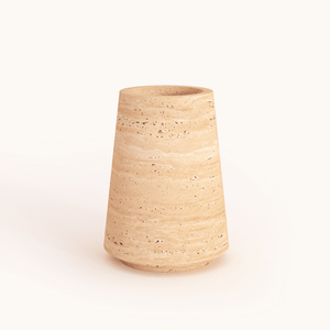 A Classic Beige Travertine Vase by Travertable, featuring a textured ceramic design with a wide base tapering slightly towards the top, set against a plain white background.