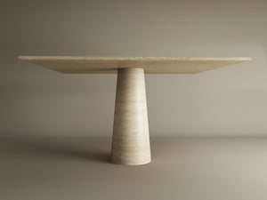 The TRAVERTABLE Square Travertine Dining Table features a light-hued stone top and a natural travertine conical pedestal base, customizable to order, shown against a plain beige background.