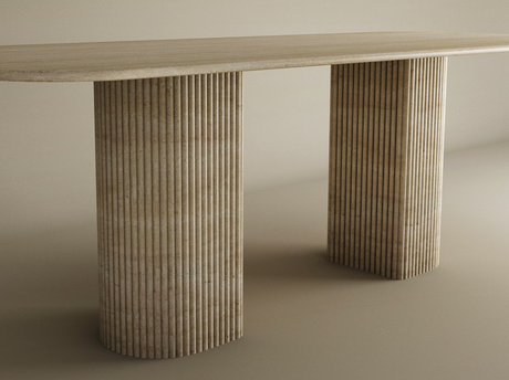 The TRAVERTABLE Rectangular Travertine Dining Table features a smooth travertine top and two fluted round solid stone bases, offering heirloom quality craftsmanship in a customizable, neutral-toned design.