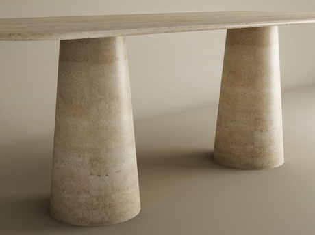 The TRAVERTABLE Rectangular Travertine Dining Table features a natural stone top and an organic travertine stone base with two wide conical pedestal legs, creating a sophisticated look on a neutral background. Customizable to your style.