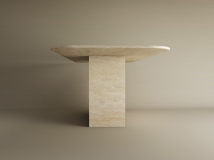The TRAVERTABLE Rectangular Travertine Dining Table features a thick natural stone top and solid block base, showcasing a timeless, minimalist design in light neutral tones. Customizable to fit your dining space.