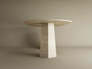 The TRAVERTABLE Oval Travertine Dining Table features a natural solid travertine tabletop and a tapered round base—customizable and minimalist, this timeless piece is set against a beige background.
