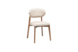 The Sleek Comfort Dining Chair by Travertable features a modern ergonomic design with a beige cushioned seat, slightly curved backrest, and wooden legs. Its minimalist style and smooth upholstery complement the natural wood finish, while the textured gray fabric adds sophistication.