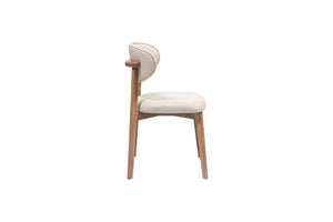 The Sleek Comfort Dining Chair by Travertable features a side view of a modern design with a light wooden frame and cushioned seat. Its ergonomic backrest has softly curved elements wrapped in textured gray fabric, enhancing its minimalist charm, set against a plain white background.