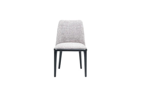 Introducing Travertables Comfort Dining Chair, boasting a modern design with a softly cushioned light gray fabric seat and backrest. Supported by four slender black legs, its ergonomic structure is highlighted against a white background for minimalist elegance.