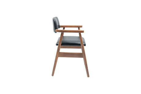 A side view of the Travertable Executive Elegance Armchair showcases wooden legs and ergonomic armrests. The seat and backrest are upholstered in dark faux leather, featuring a minimalist design with clean lines against a white background.