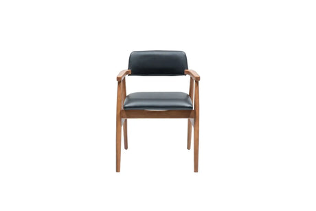 Travertables Executive Elegance Armchair features sleek faux leather upholstery. With a minimalist design, wooden frame, and ergonomic armrests, its black cushioned seat and backrest create a stunning blend of comfort and style against a white backdrop.