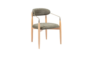 The Orion Designer Chair by Travertable features a modern design with a green cushioned backrest and seat, supported by light wood legs. Its metallic armrests curve outward slightly, offering ergonomic comfort while maintaining a sleek, contemporary look.